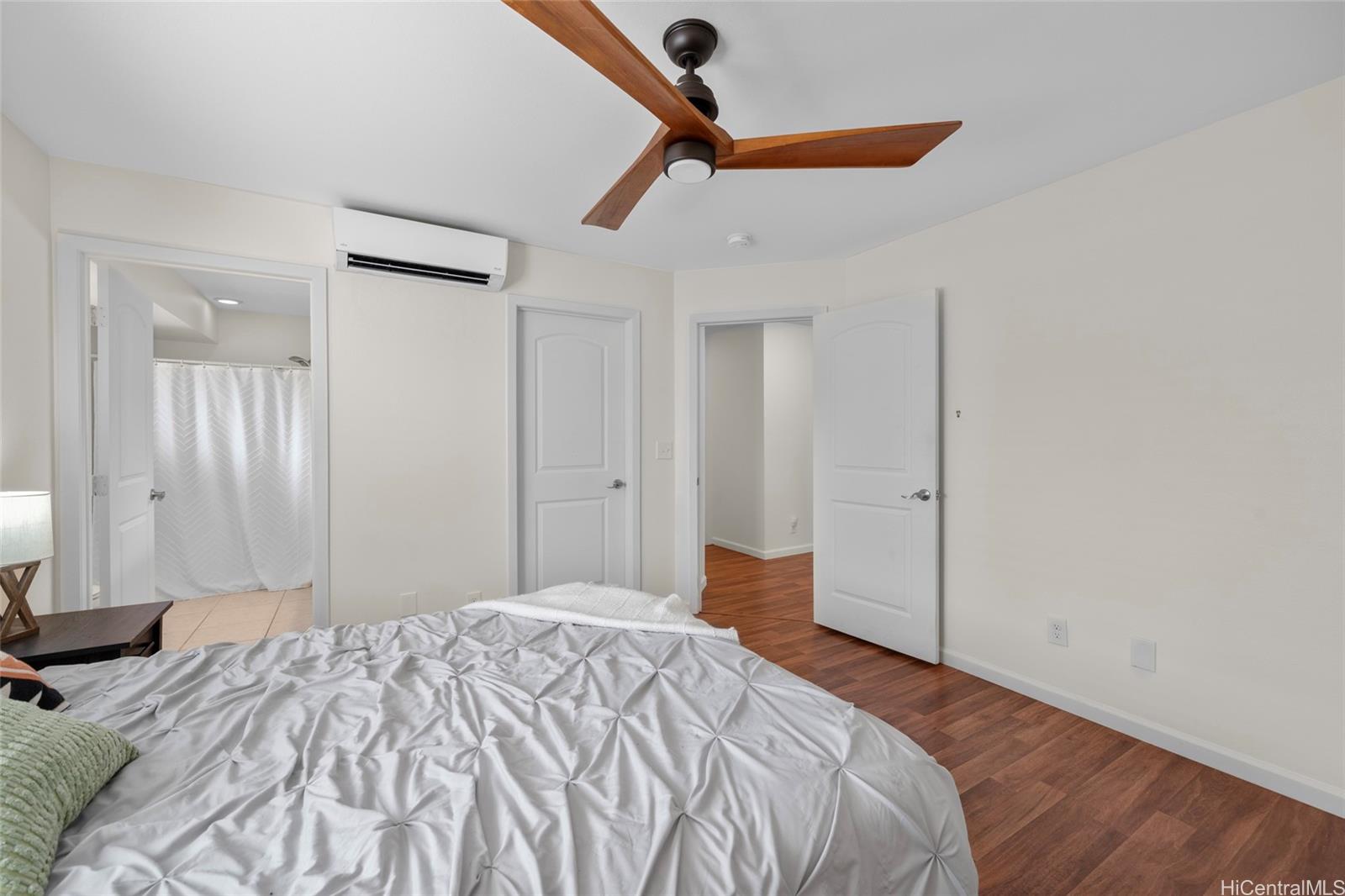 87-176 Maipalaoa Road, Unit D12 Waianae, HI 96792 - Photo 15 of 25 a bedroom with a bed and a chandelier