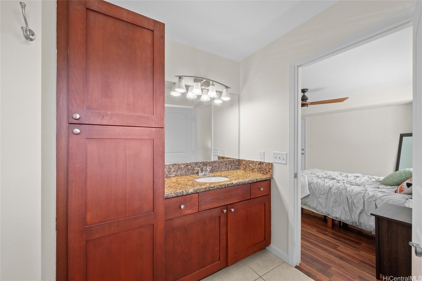 87-176 Maipalaoa Road, Unit D12 Waianae, HI 96792 - Photo 16 of 25 a bedroom with a bed and a mirror