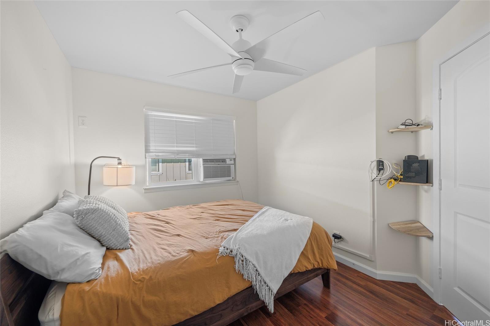 87-176 Maipalaoa Road, Unit D12 Waianae, HI 96792 - Photo 18 of 25 a bedroom with a bed and a table