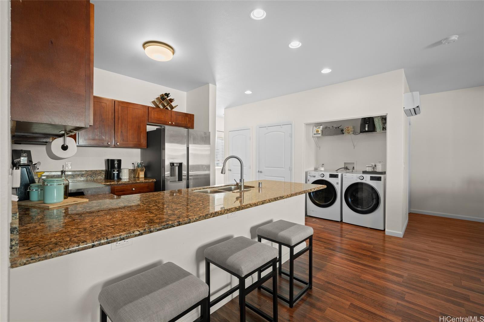 87-176 Maipalaoa Road, Unit D12 Waianae, HI 96792 - Photo 2 of 25 a kitchen with stainless steel appliances granite countertop a table and chairs