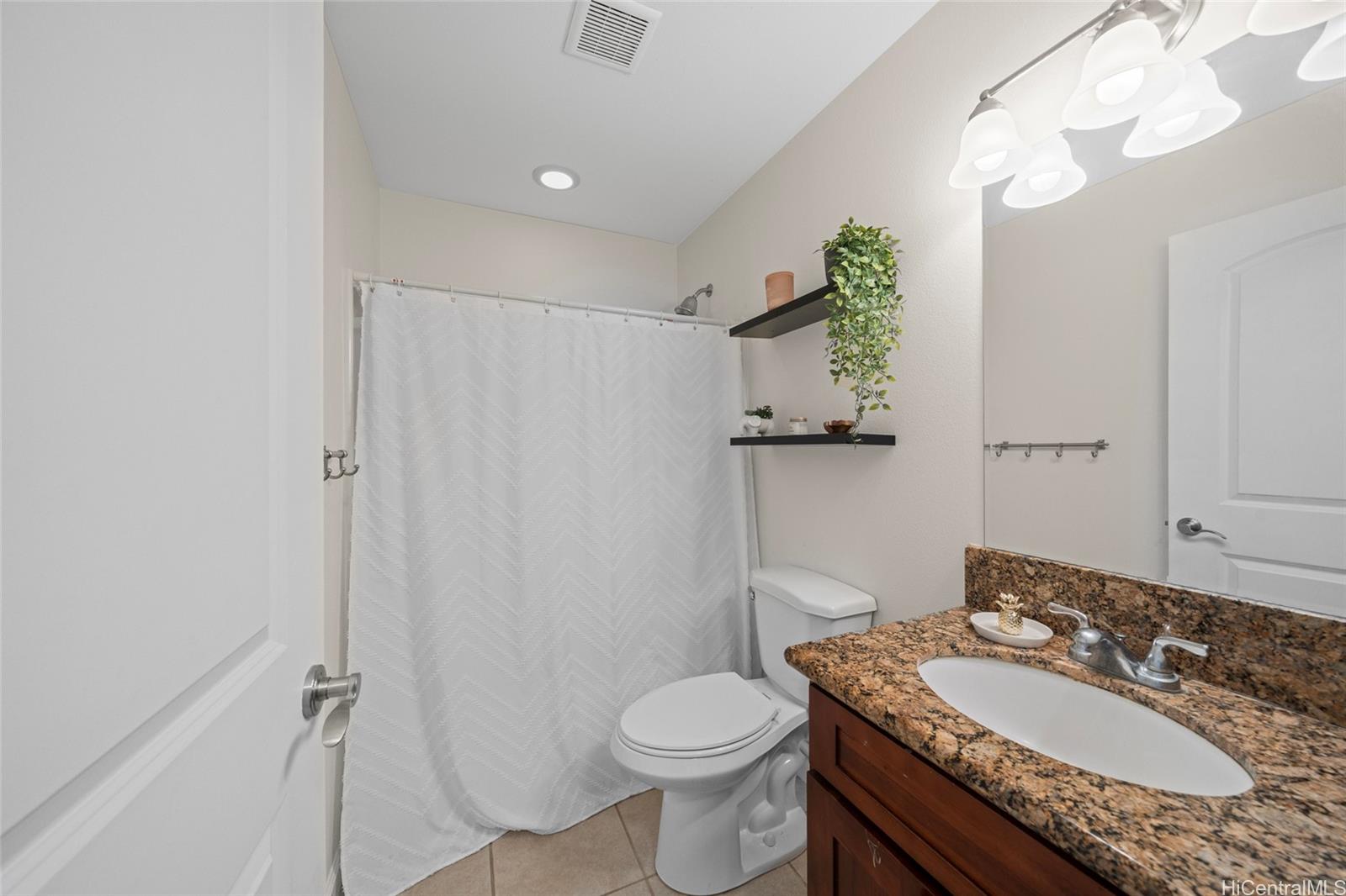 87-176 Maipalaoa Road, Unit D12 Waianae, HI 96792 - Photo 21 of 25 a bathroom with a granite countertop sink toilet and shower