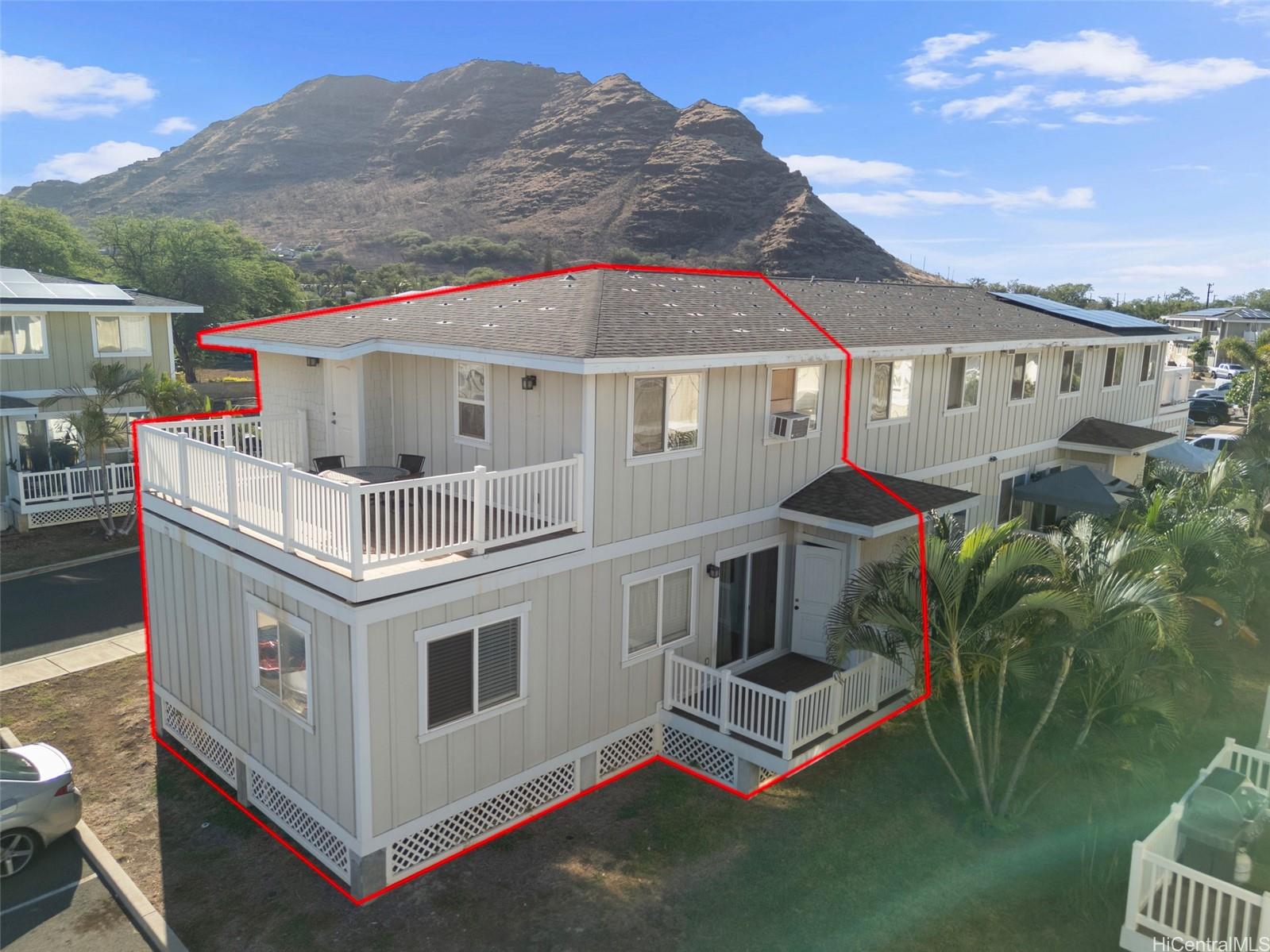 87-176 Maipalaoa Road, Unit D12 Waianae, HI 96792 - Photo 24 of 25 a white house with a big yard and large trees