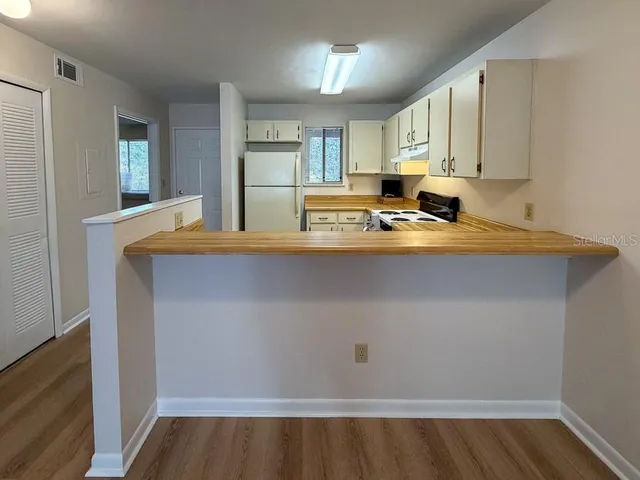 a view of kitchen with wooden floor