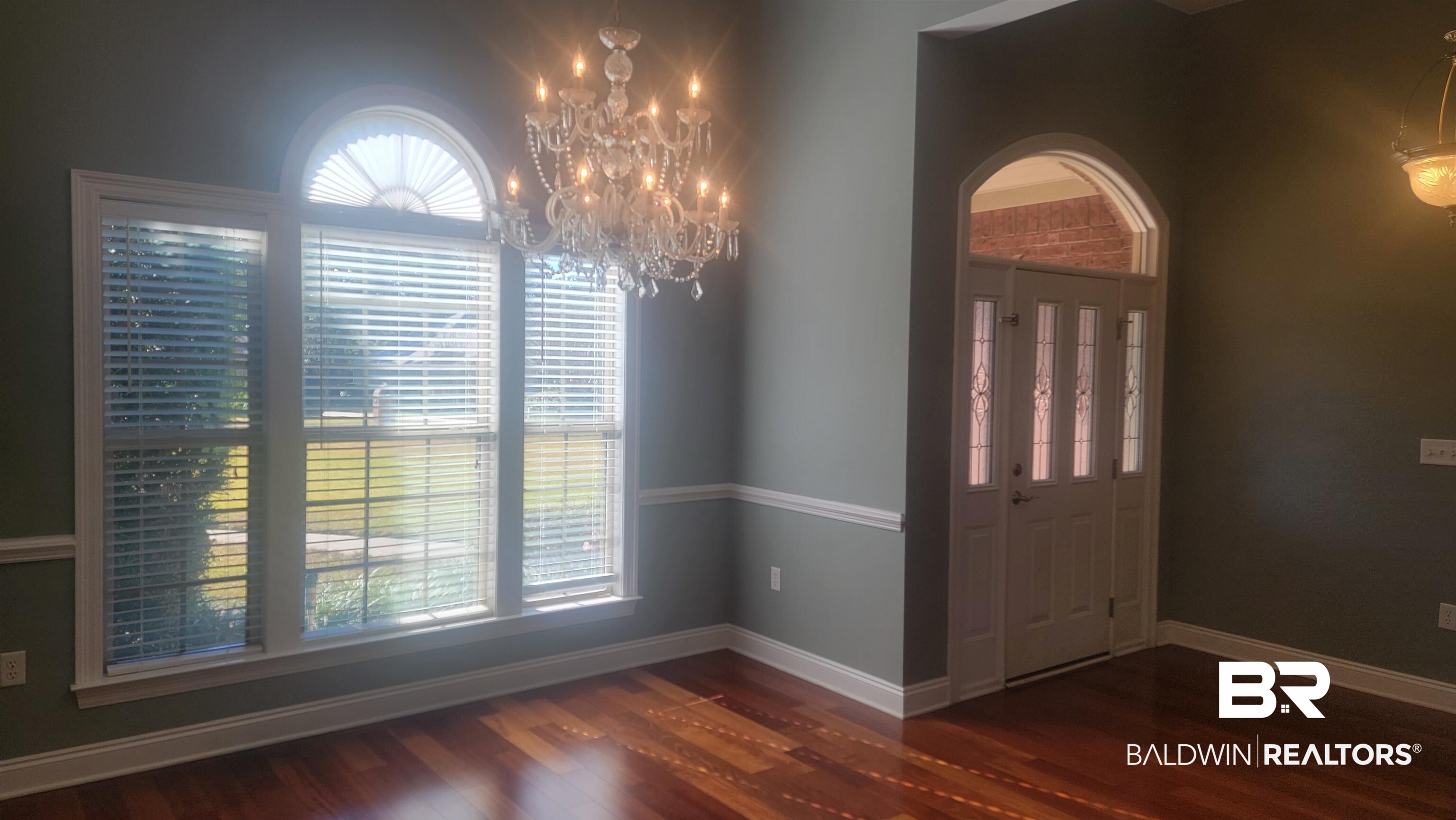 306 South Tee Drive Fairhope, AL 36532 - Photo 9 of 37 Foyer entrance with a notable chandelier, dark wood-type flooring, and a wealth of natural light
