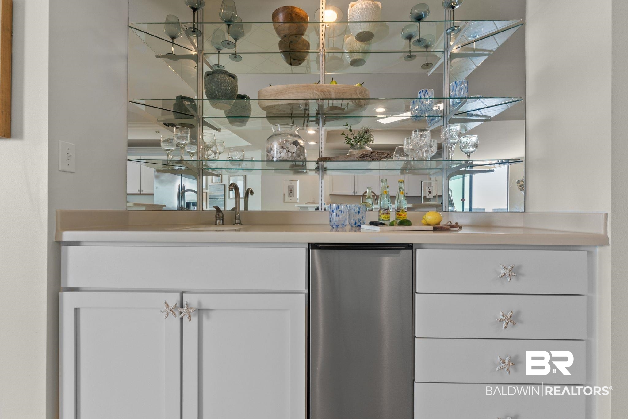 27580 Canal Road, Unit 1233 Orange Beach, AL 36561 - Photo 41 of 79 Indoor wet bar featuring stainless steel appliances, white cabinetry, light countertops, and open shelves
