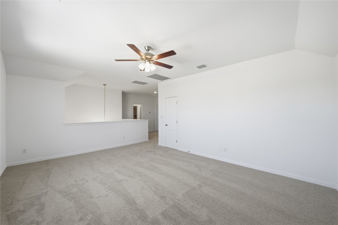 205 Caraway Drive Taylor, TX 76574 - Photo 11 of 15 Spare room with light colored carpet and a ceiling fan