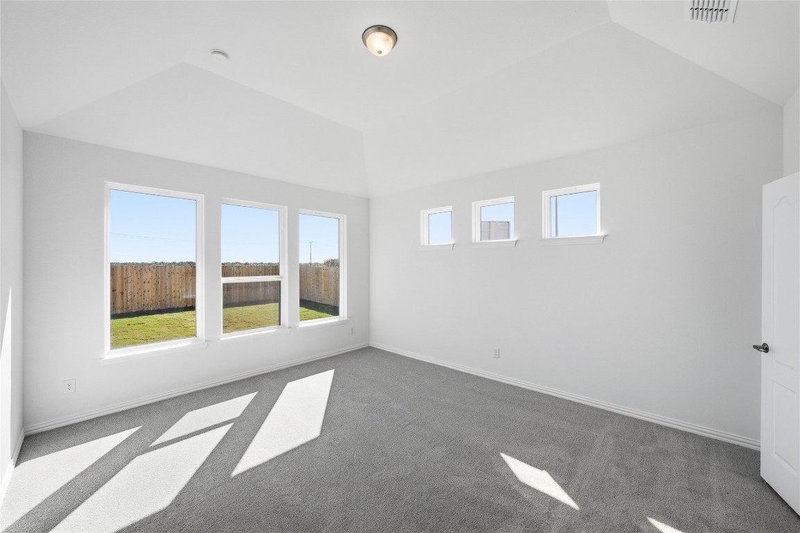 205 Caraway Drive Taylor, TX 76574 - Photo 8 of 15 Carpeted empty room featuring baseboards