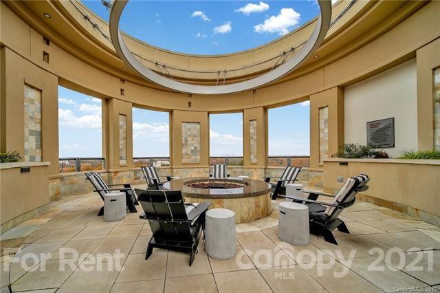 4300 Sharon Road, Unit 531 Charlotte, NC 28211 - Photo 5 of 10 a dining room with furniture and floor to ceiling windows