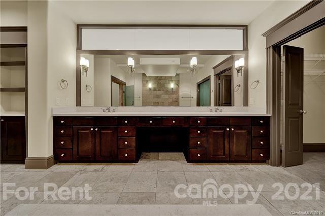 4300 Sharon Road, Unit 531 Charlotte, NC 28211 - Photo 10 of 10 a bathroom with a sink and a large mirror