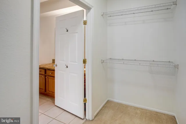 a view of walk in closet with white walls