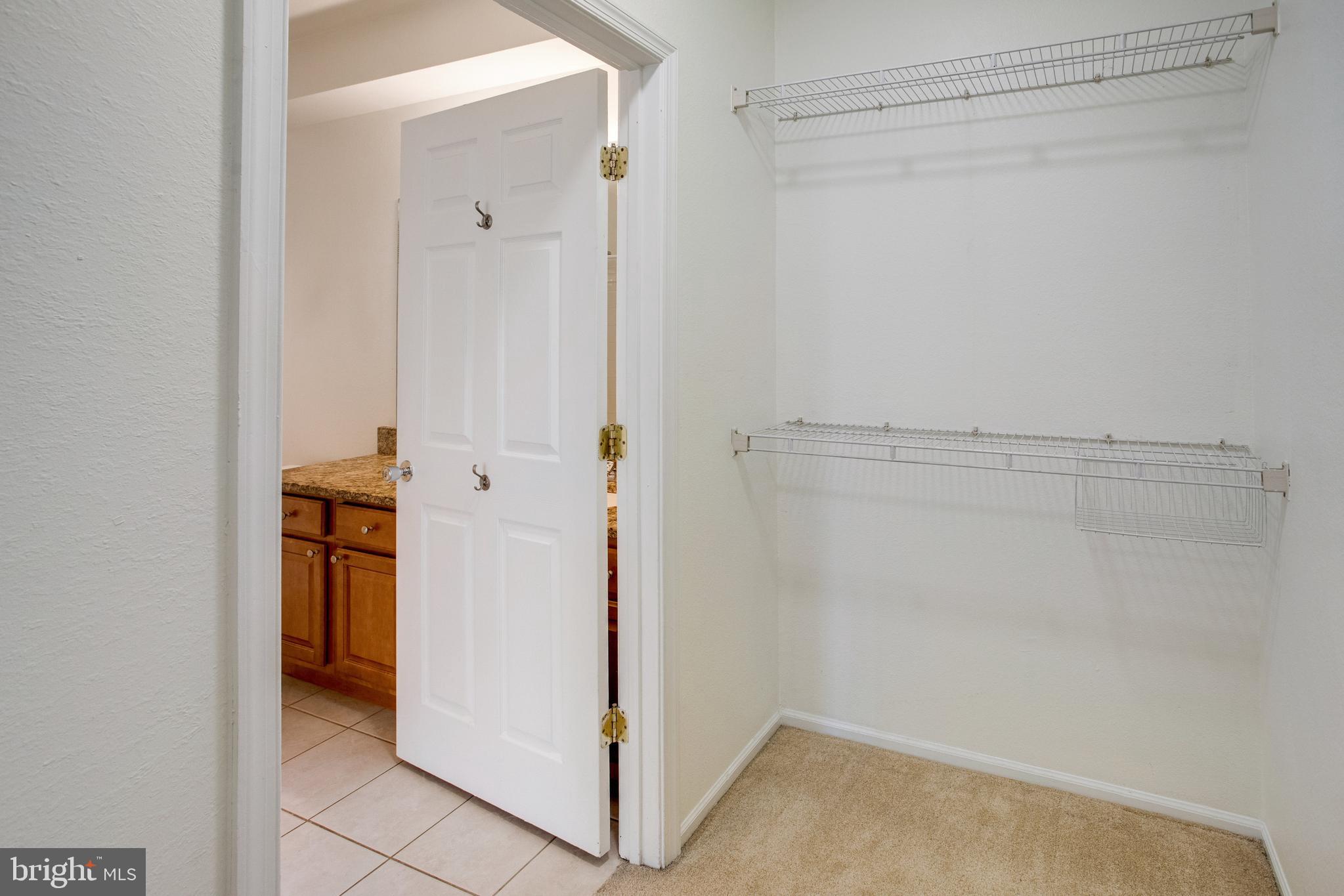 1530 Spring Gate Dr., Unit 9308 McLean, VA 22102 - Photo 18 of 38 a view of walk in closet with white walls