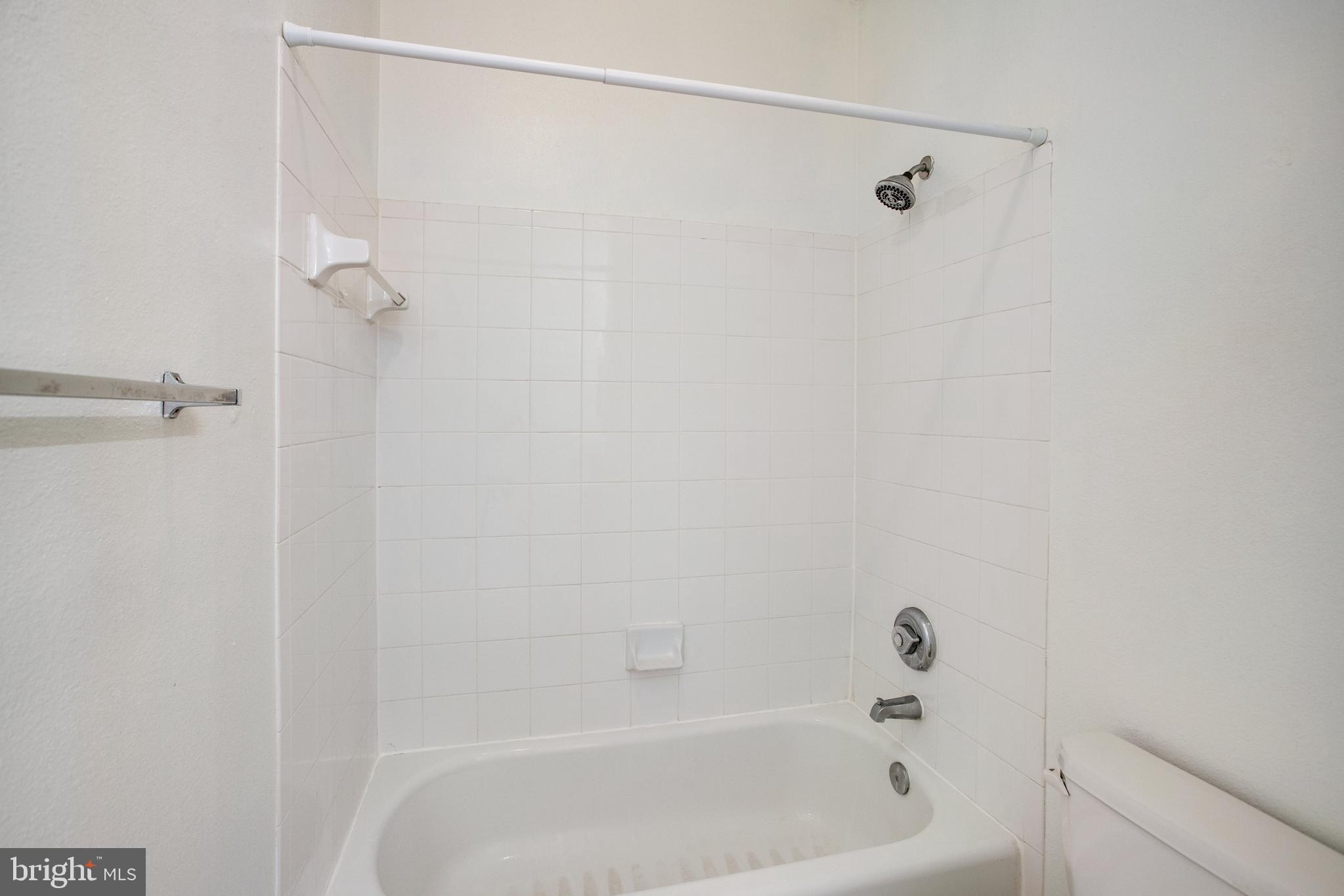 1530 Spring Gate Dr., Unit 9308 McLean, VA 22102 - Photo 28 of 38 a bathroom with a shower and a bath tub