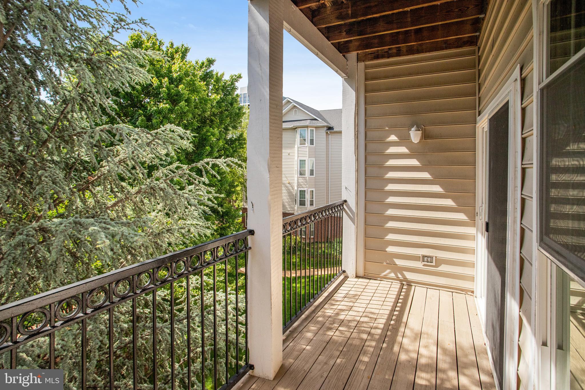 1530 Spring Gate Dr., Unit 9308 McLean, VA 22102 - Photo 31 of 38 a view of a balcony with wooden floor and fence