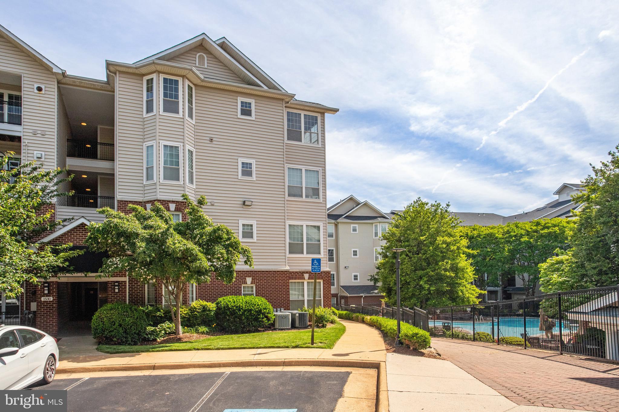1530 Spring Gate Dr., Unit 9308 McLean, VA 22102 - Photo 33 of 38 a front view of a house with a yard