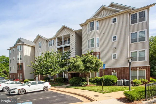 a car parked in front of a white house