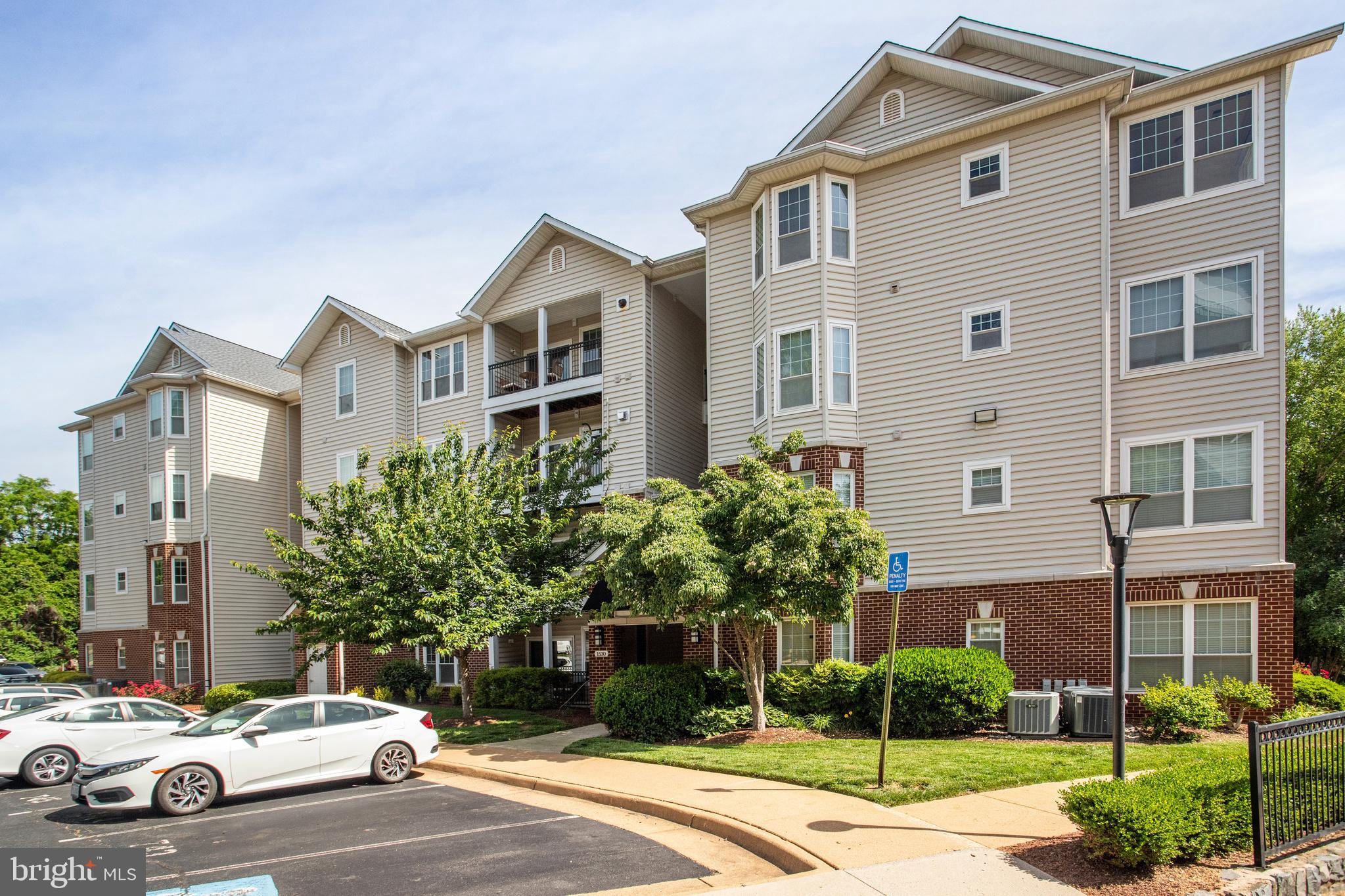 1530 Spring Gate Dr., Unit 9308 McLean, VA 22102 - Photo 36 of 38 a car parked in front of a white house
