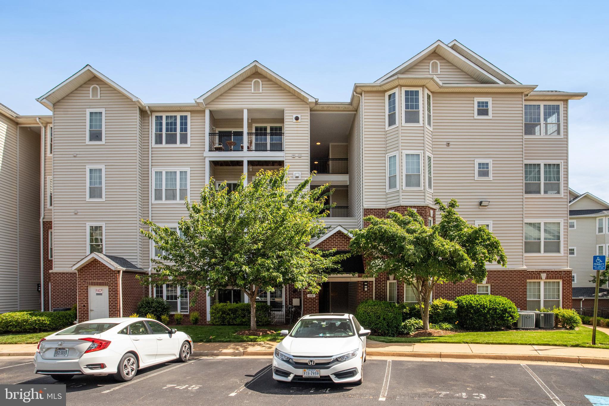 1530 Spring Gate Dr., Unit 9308 McLean, VA 22102 - Photo 37 of 38 a car parked in front of a white house