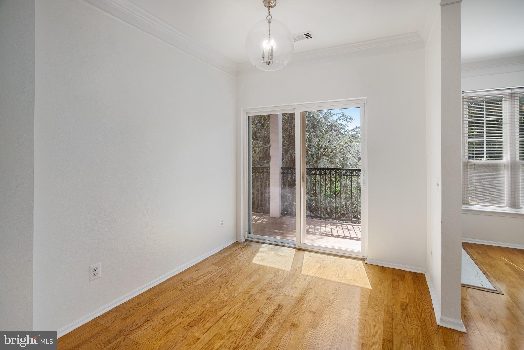 1530 Spring Gate Dr., Unit 9308 McLean, VA 22102 - Photo 7 of 38 an empty room with wooden floor and windows