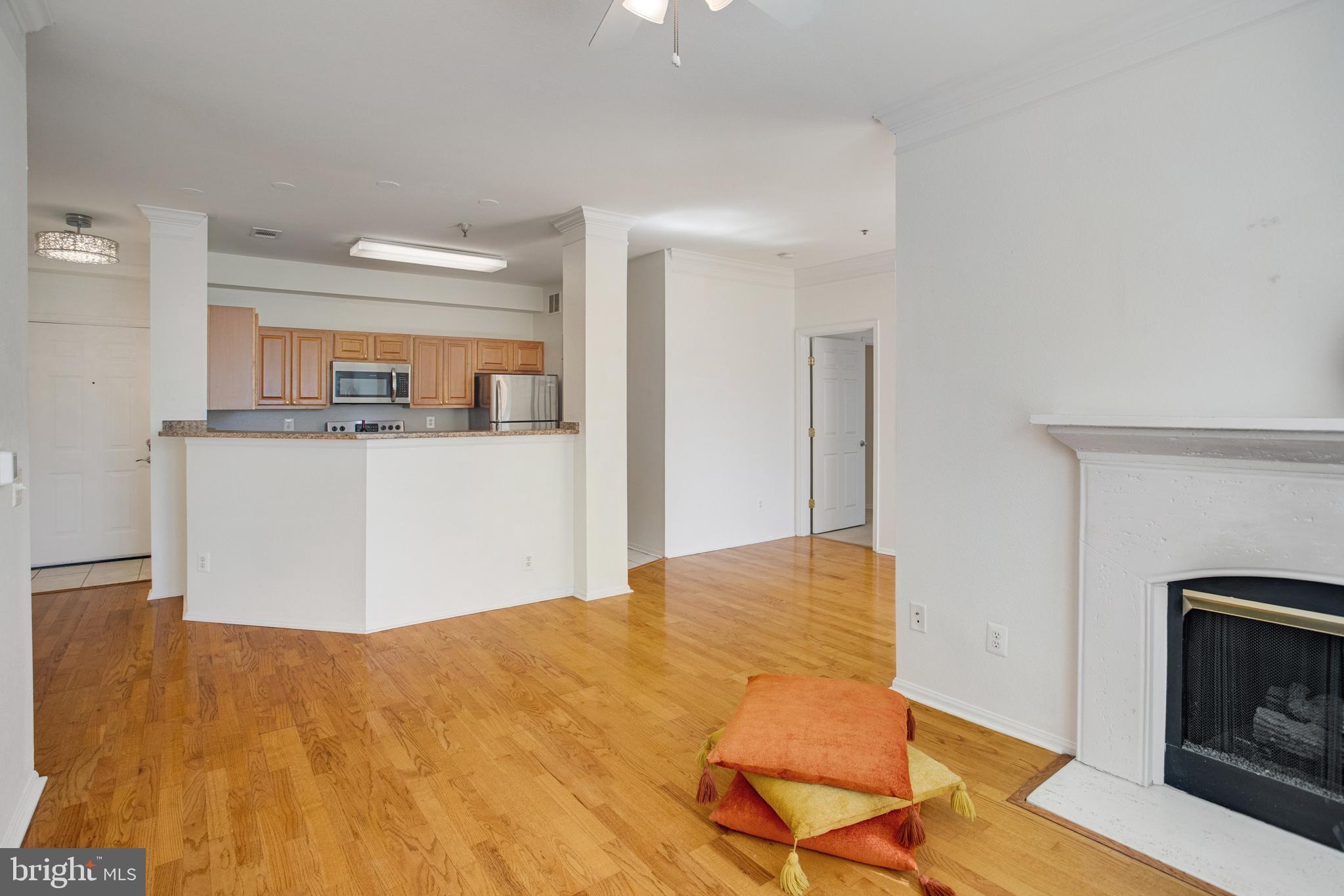 1530 Spring Gate Dr., Unit 9308 McLean, VA 22102 - Photo 9 of 38 a workspace with kitchen island and wooden floor