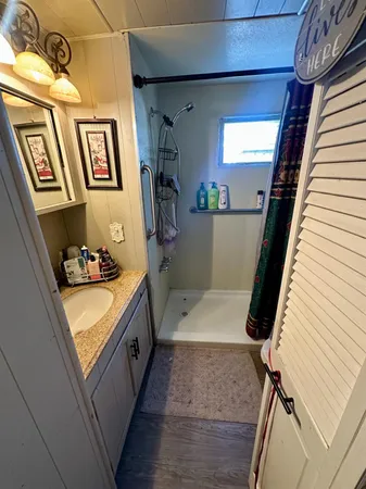 a bathroom with a tub sink and mirror