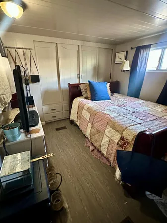 a bedroom with a bed and dresser