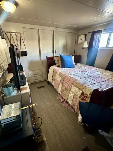 a bedroom with a bed and dresser