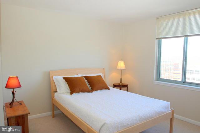 851 North Glebe Road, Unit 1311 Arlington, VA 22203 - Photo 11 of 30 a bedroom with a bed and a lamp next to a window