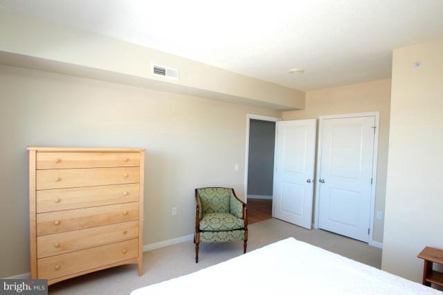 851 North Glebe Road, Unit 1311 Arlington, VA 22203 - Photo 13 of 30 a bedroom with a bed and a chair