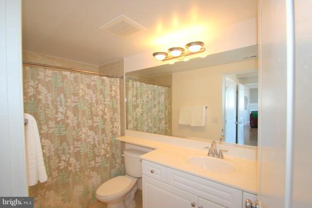 851 North Glebe Road, Unit 1311 Arlington, VA 22203 - Photo 14 of 30 a bathroom with a sink a toilet and shower