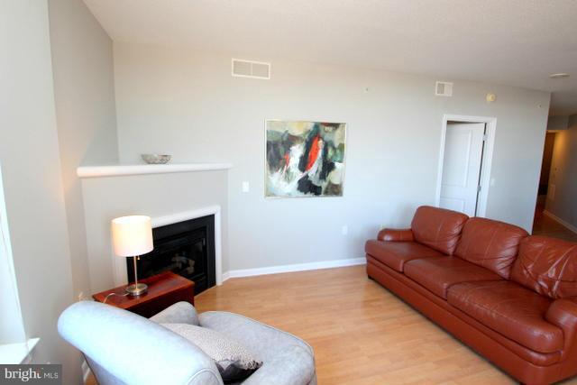 851 North Glebe Road, Unit 1311 Arlington, VA 22203 - Photo 3 of 30 a living room with furniture and a fireplace