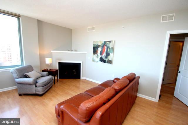 851 North Glebe Road, Unit 1311 Arlington, VA 22203 - Photo 4 of 30 a living room with furniture and a fireplace