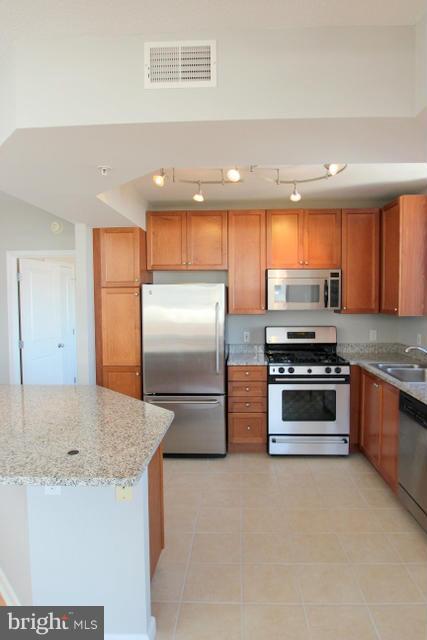 851 North Glebe Road, Unit 1311 Arlington, VA 22203 - Photo 10 of 30 a kitchen with stainless steel appliances granite countertop a refrigerator and a sink