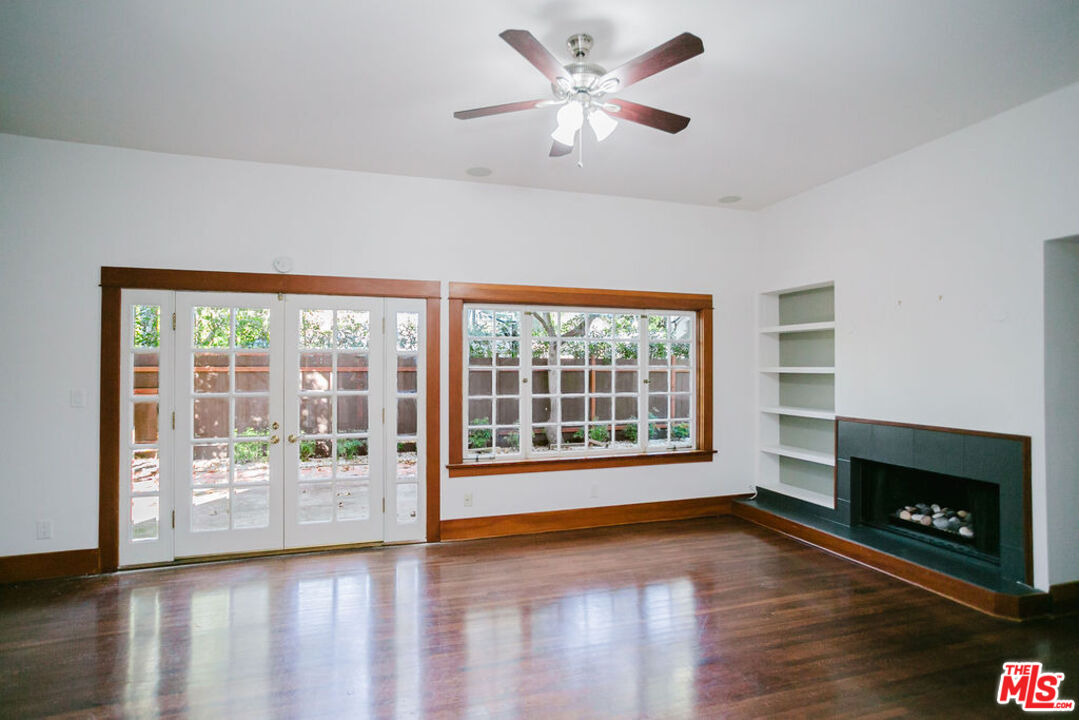 13239 Addison Street Sherman Oaks, CA 91423 - Photo 6 of 29 a view of an empty room with a fireplace and a window