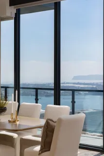 a view of balcony with a large window and wooden floor