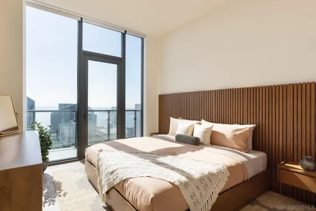 a bedroom with a bed and a large window