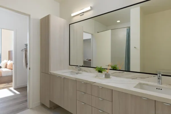 a kitchen with a dining table chairs wooden floor cabinets and stainless steel appliances
