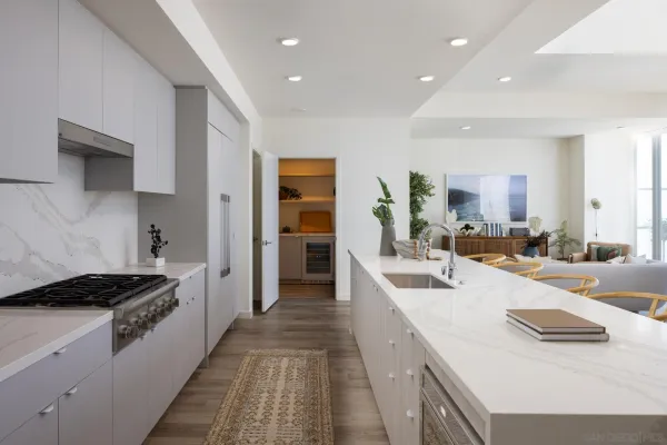 a living room with furniture and large windows