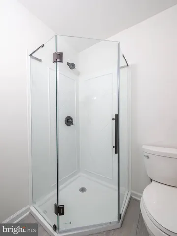 a bathroom with a shower a toilet and a shower