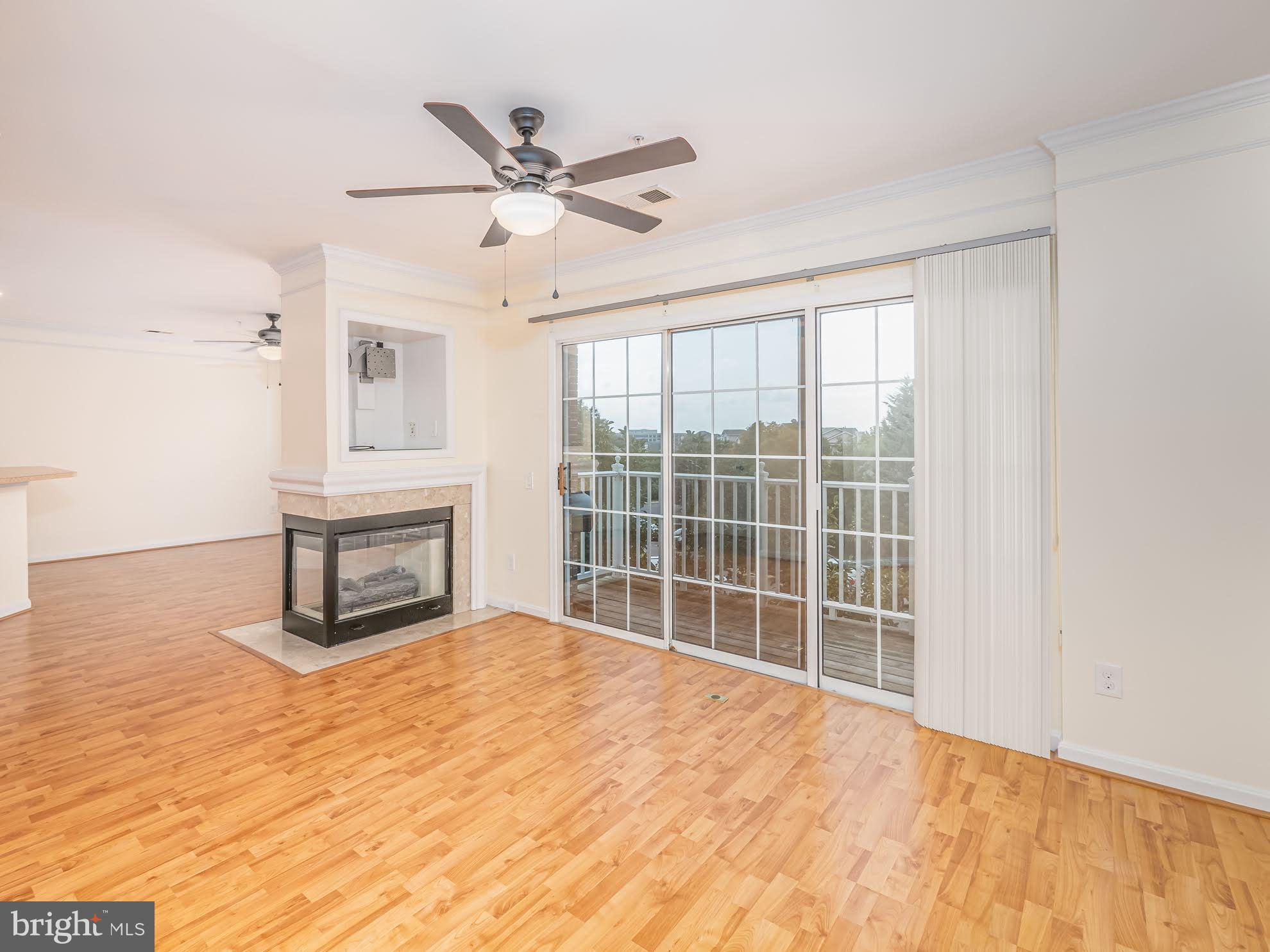 12755 Fair Crest Court, Unit 301 Fairfax, VA 22033 - Photo 2 of 24 a view of an empty room with wooden floor and a window