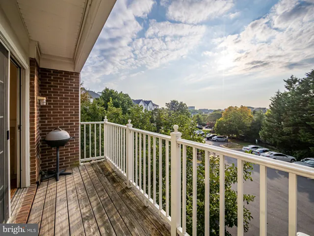 a view of balcony with wooden floor and fence