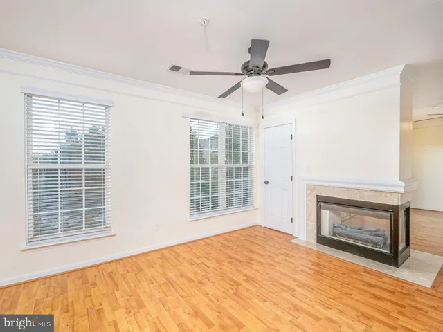 a view of empty room with a fireplace and fan