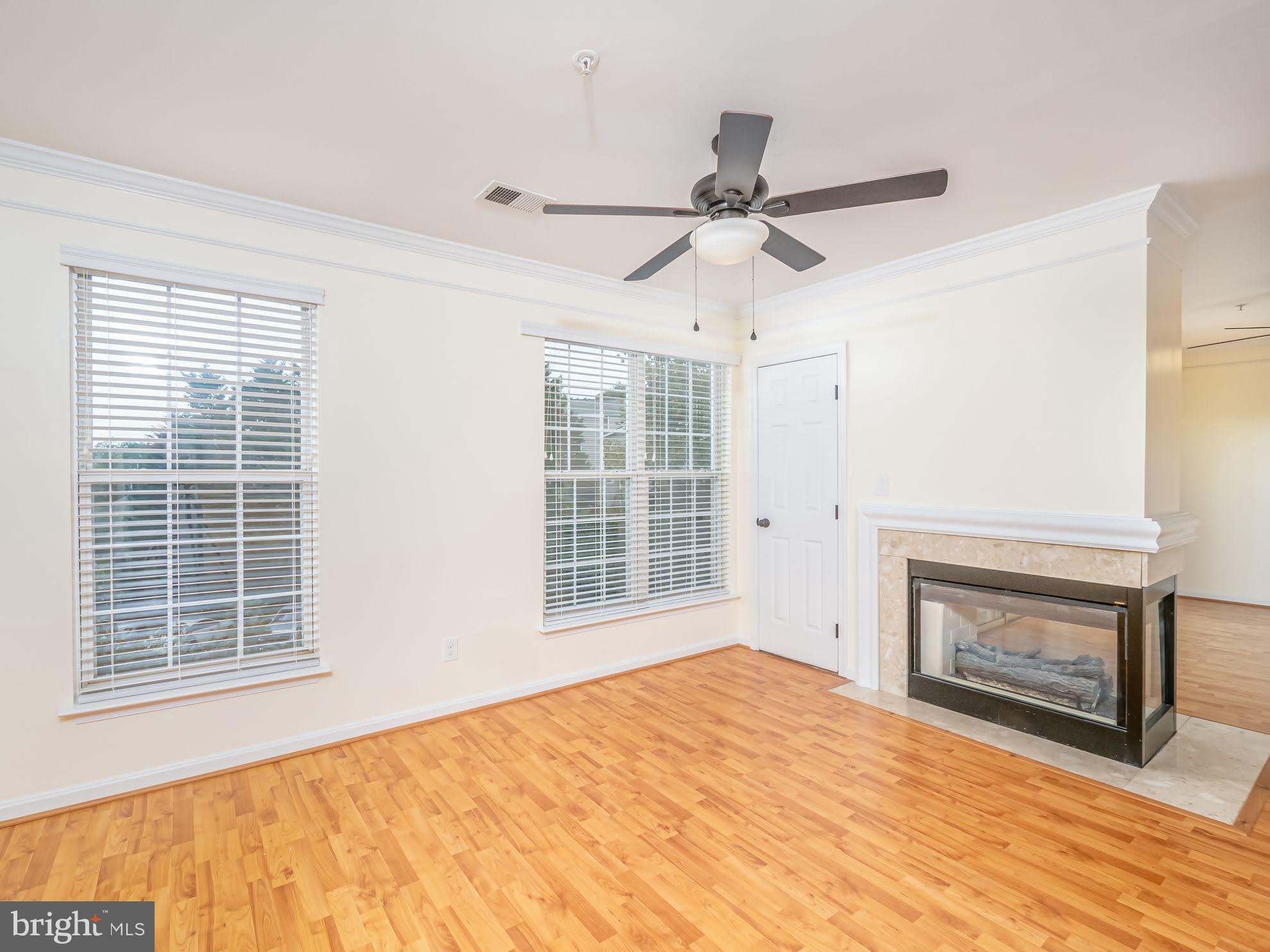 12755 Fair Crest Court, Unit 301 Fairfax, VA 22033 - Photo 5 of 24 a view of empty room with a fireplace and fan