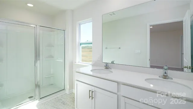 a bathroom with double vanity sink and a mirror