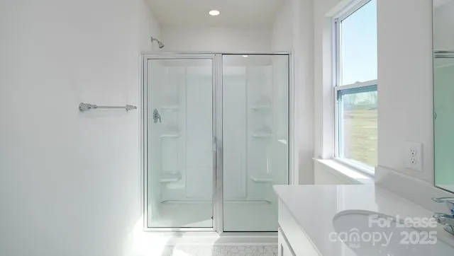 a bathroom with a shower and a sink