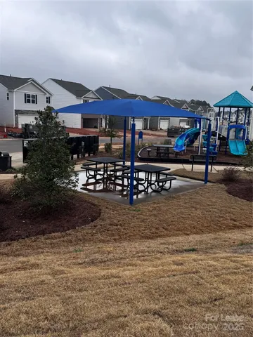 a view of a big house with large trees next to a road