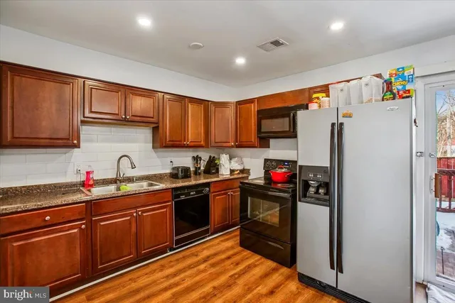 a kitchen with refrigerator and cabinets