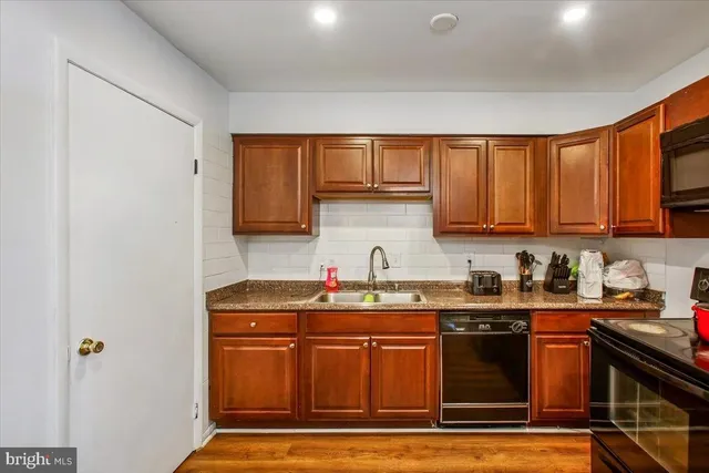 a kitchen with stainless steel appliances granite countertop a sink stove and cabinets