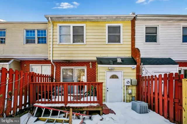 a front view of a house with balcony and furniture