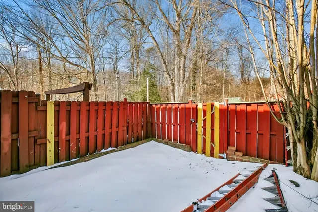 a view of a backyard with wooden fence