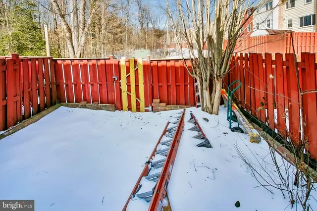 a view of a backyard with wooden fence